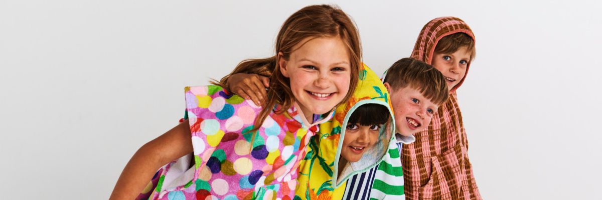 Two children wearing colourful raincoats