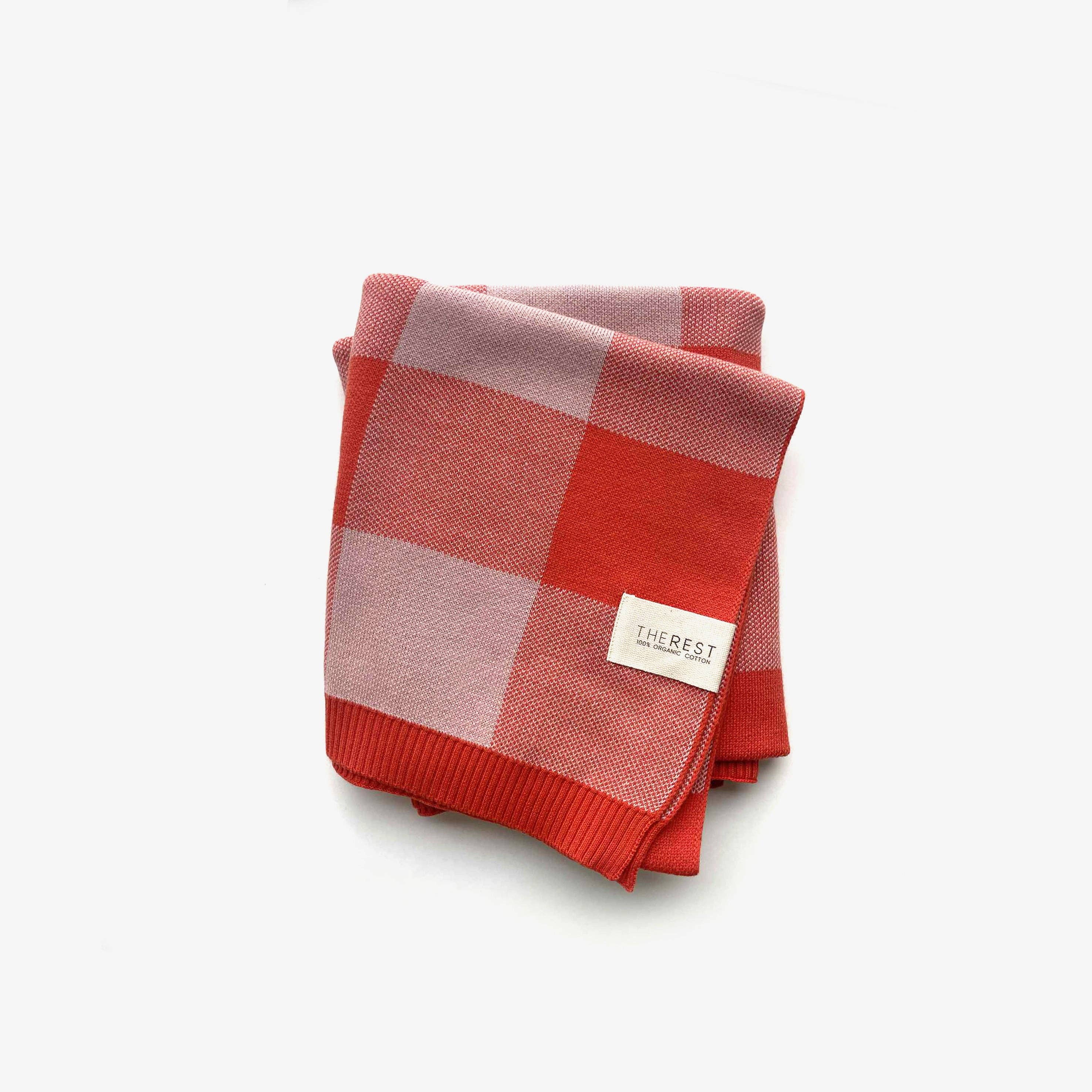 The Rest Organic Cotton Knit Blanket in Bubblegum Picnic — front view flat lay