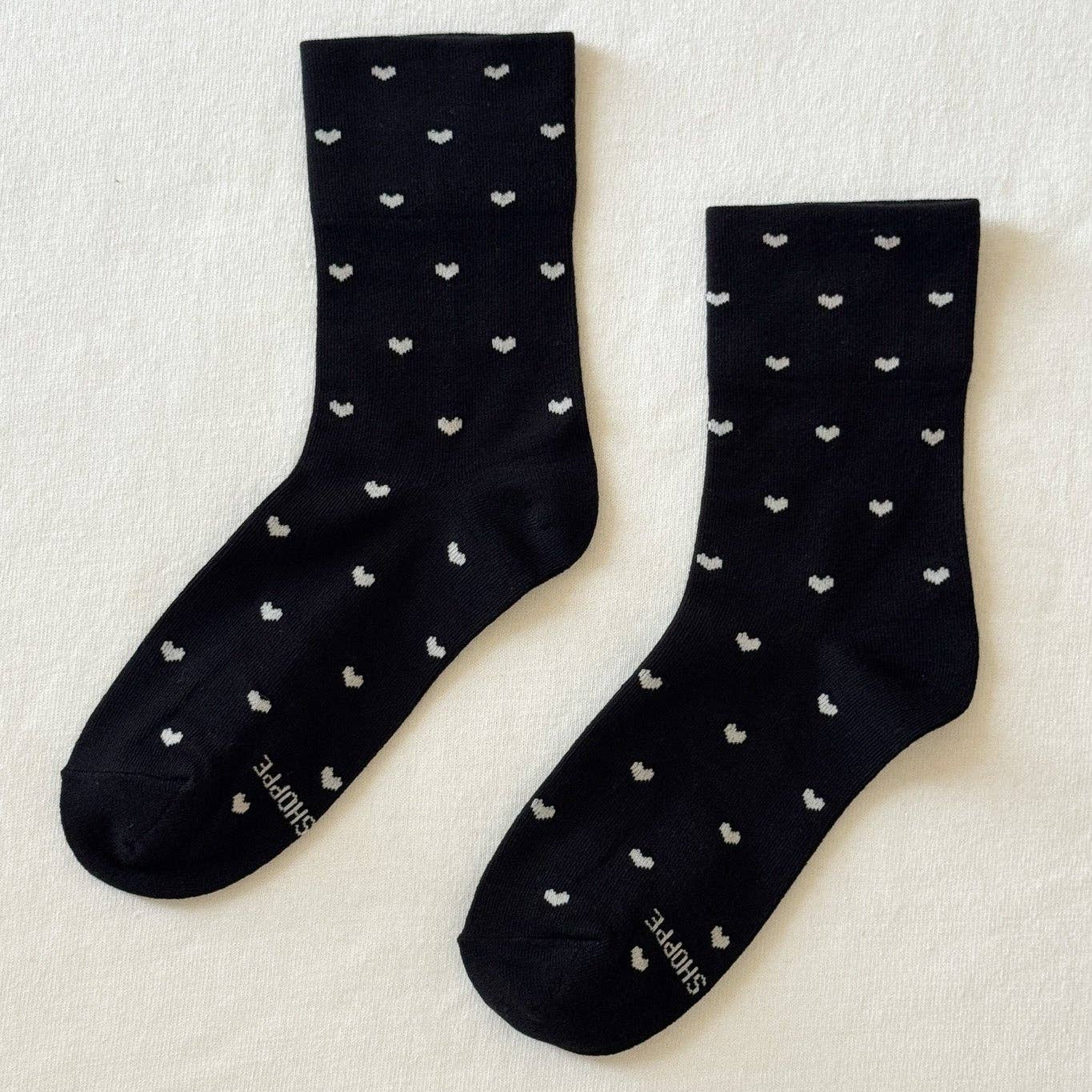 Black and cream heart-print sneaker socks by Le Bon Shoppe